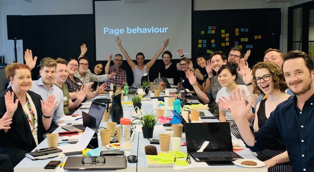 Picture of smiling participants and trainers with hands in the air. Sarah Richards is in the centre.